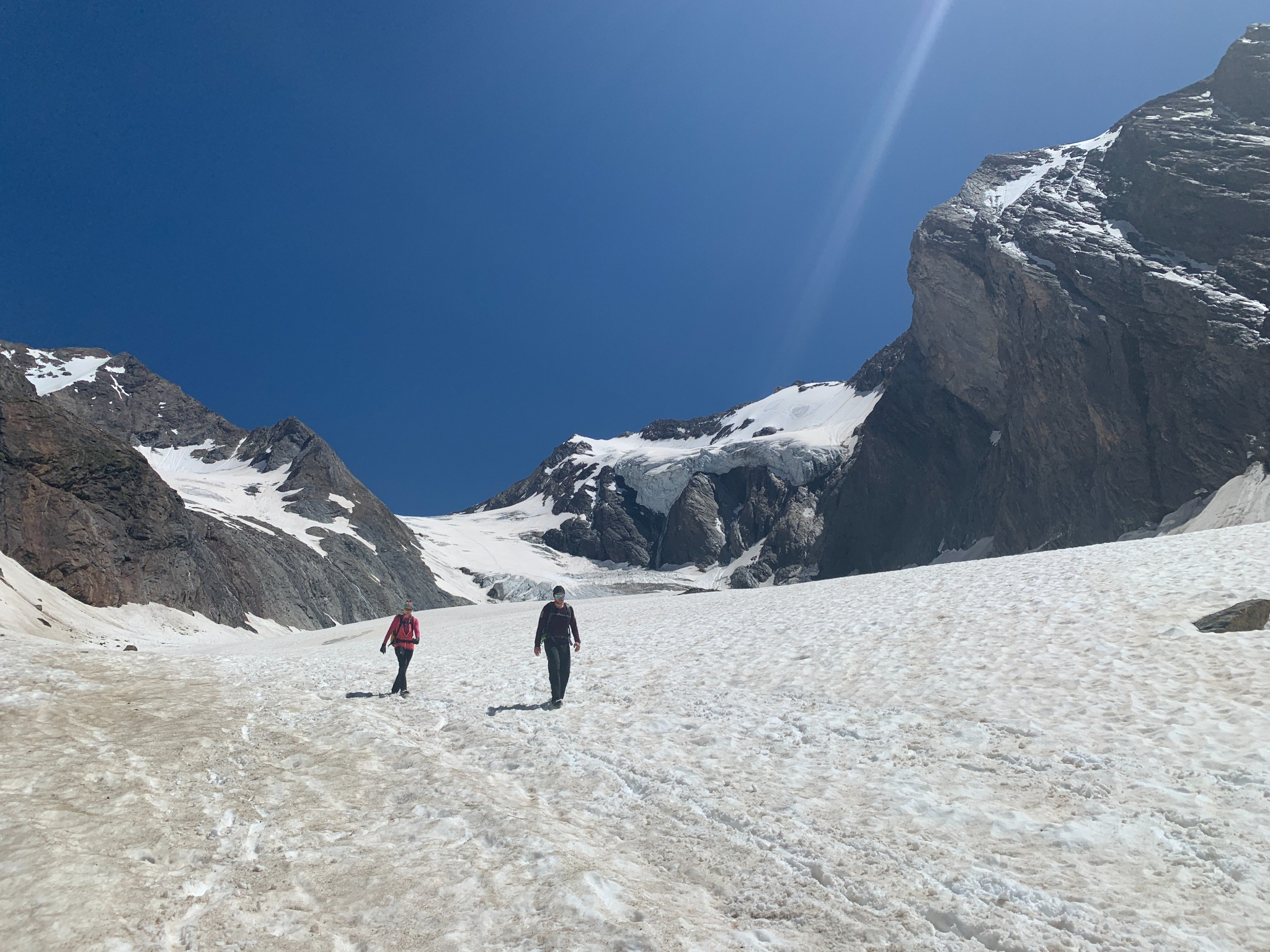 Two mountaineers crossing the glacier between the mountains above Obergurgl