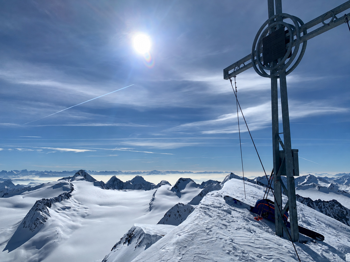Summit cross and snowy Alpine panorama on the Schalfkogel