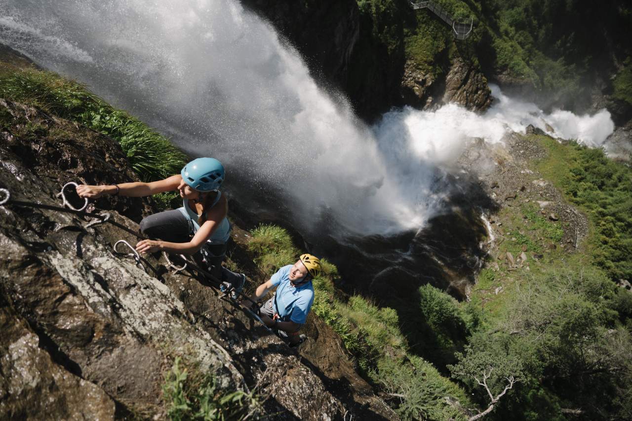 Climbers beside the Stuibenfall waterfall on a guided via ferrata