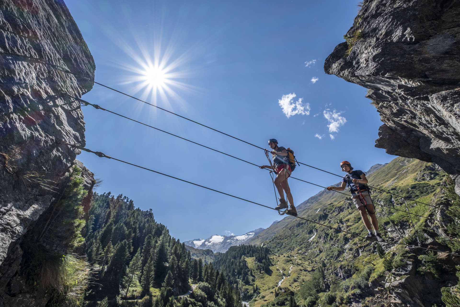 Climbers crossing a rope bridge on the Zirbenwald via ferrata